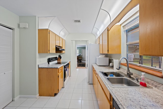 kitchen with light tile patterned floors, white appliances, and sink