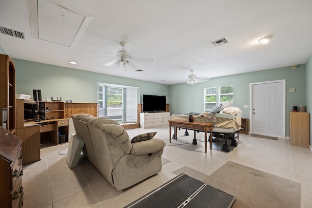 living room with ceiling fan and light tile patterned flooring