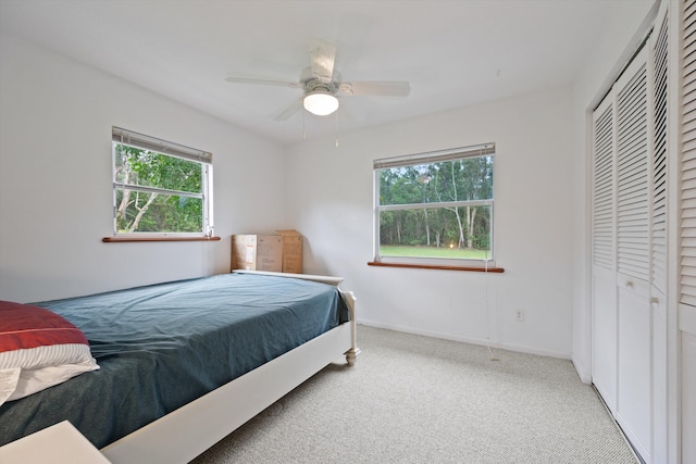 bedroom with carpet, a closet, and ceiling fan