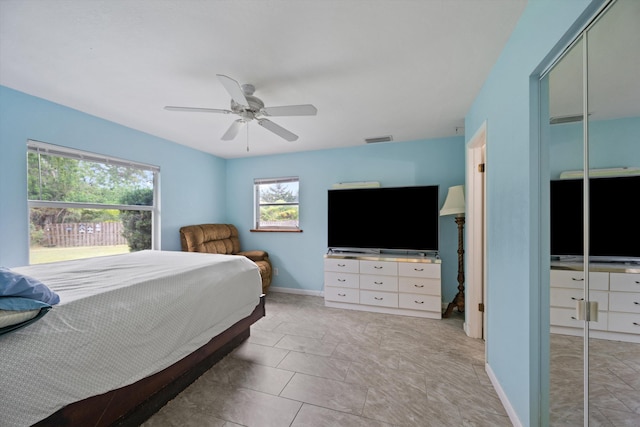 bedroom with ceiling fan and light tile patterned floors