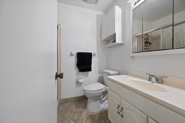 bathroom featuring vanity, a shower with shower door, and toilet