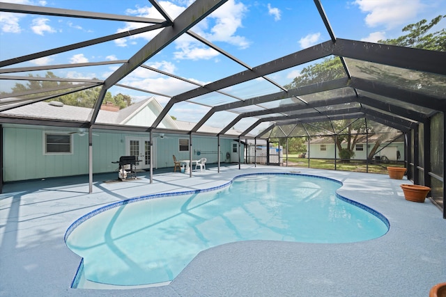 view of pool featuring a lanai, a patio, and french doors