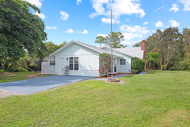 rear view of property featuring a yard