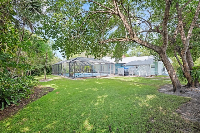 view of yard featuring a pool and glass enclosure