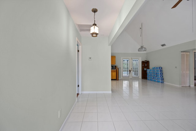 unfurnished living room featuring ceiling fan, french doors, light tile patterned floors, and high vaulted ceiling