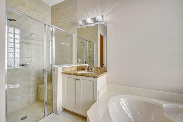 bathroom with tile patterned flooring, vanity, and shower with separate bathtub