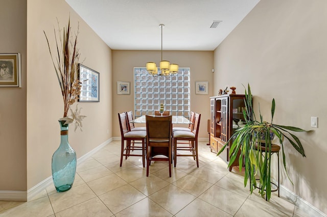 dining space featuring a notable chandelier and light tile patterned floors