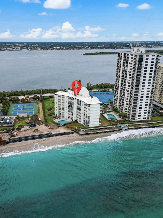 aerial view with a water view and a beach view