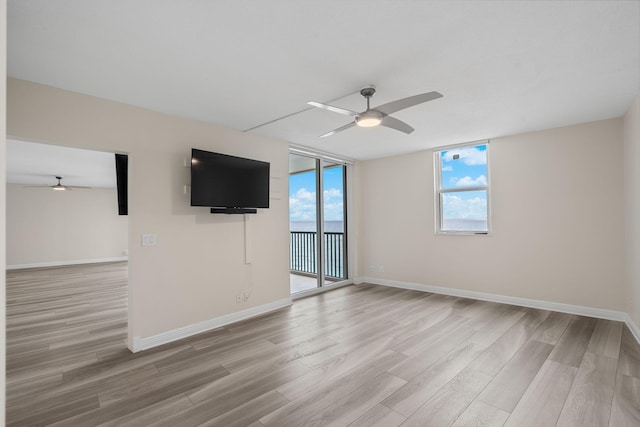 spare room featuring ceiling fan and light wood-type flooring