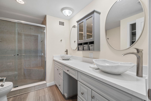 bathroom with vanity, an enclosed shower, hardwood / wood-style floors, and toilet