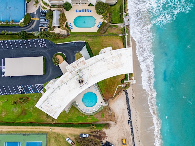 drone / aerial view featuring a water view and a view of the beach