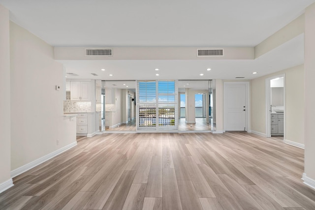 unfurnished living room with light hardwood / wood-style floors