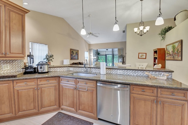 kitchen featuring dishwasher, sink, pendant lighting, vaulted ceiling, and ceiling fan with notable chandelier