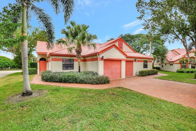 view of front of house with a front yard and a garage