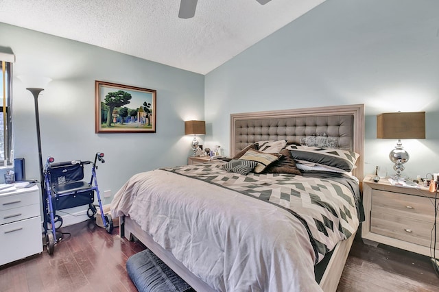 bedroom with lofted ceiling, a textured ceiling, ceiling fan, and dark wood-type flooring