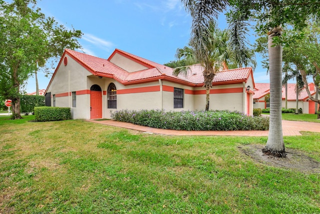 mediterranean / spanish home featuring a front yard