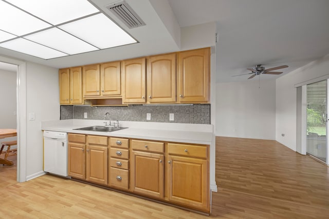 kitchen featuring light wood-type flooring, tasteful backsplash, ceiling fan, sink, and dishwasher