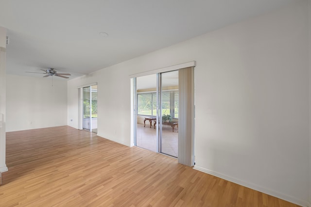 empty room with light hardwood / wood-style flooring and ceiling fan