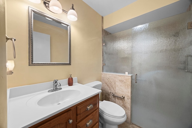 bathroom with vanity, a shower with shower door, and toilet