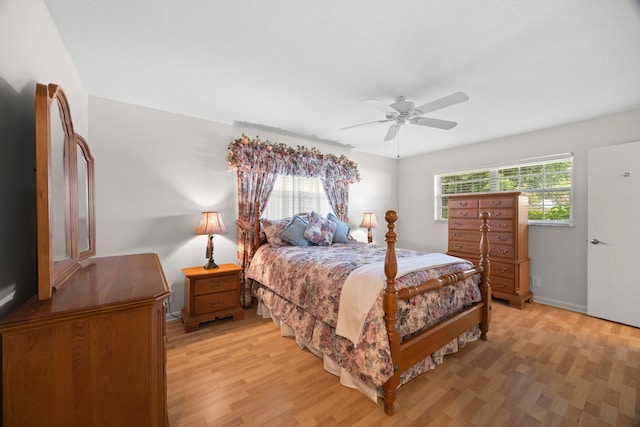 bedroom with ceiling fan and light wood-type flooring