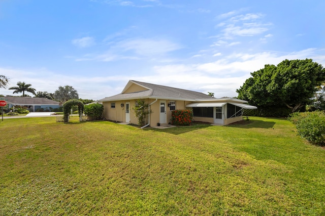 exterior space with a lawn and a sunroom