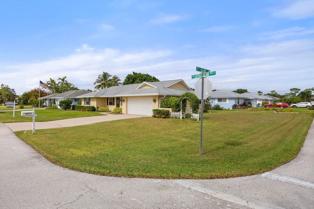 ranch-style house featuring a front yard and a garage