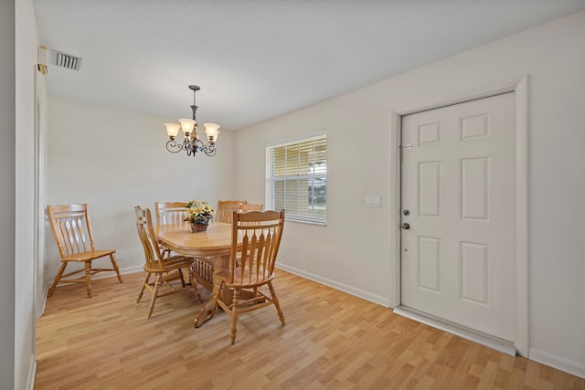 dining room featuring a chandelier and light hardwood / wood-style floors