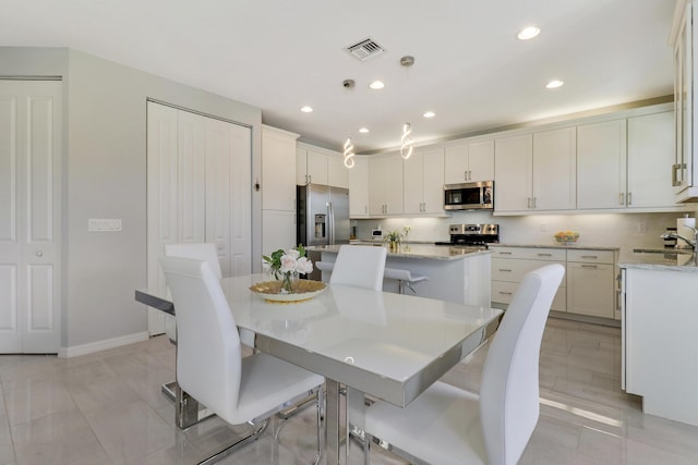 dining area featuring light tile patterned flooring