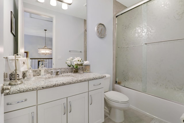 full bathroom featuring combined bath / shower with glass door, vanity, and toilet