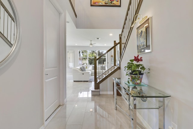 foyer entrance with ceiling fan