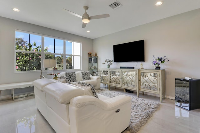 living room with ceiling fan and beverage cooler