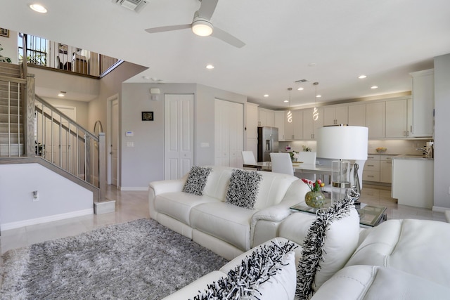 living room with ceiling fan and sink