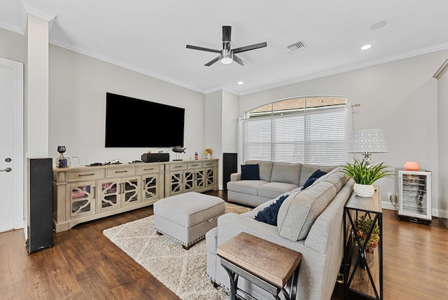 living room featuring ceiling fan, dark hardwood / wood-style flooring, and ornamental molding