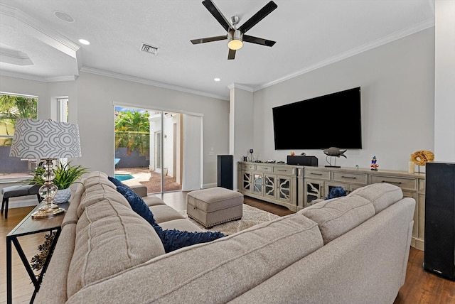 living room with wood-type flooring, a textured ceiling, and ornamental molding