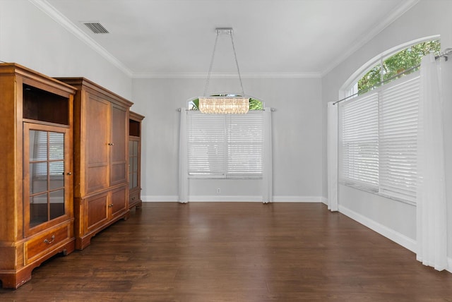 unfurnished dining area featuring dark hardwood / wood-style flooring, an inviting chandelier, and ornamental molding