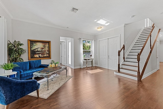 living room with hardwood / wood-style floors and ornamental molding