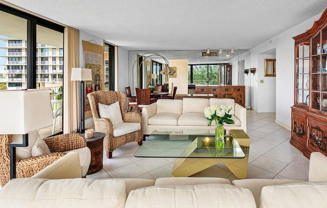 tiled living room featuring a textured ceiling and track lighting