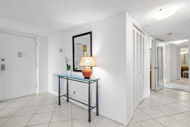 tiled entrance foyer with a textured ceiling