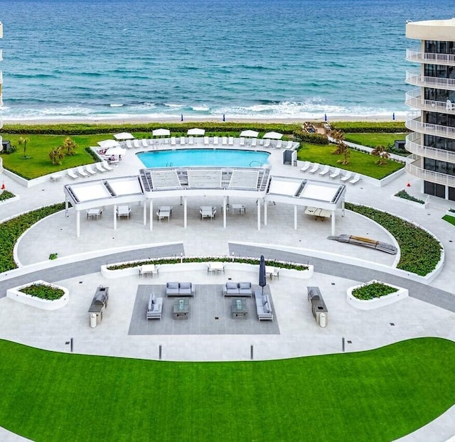 birds eye view of property with a water view and a view of the beach