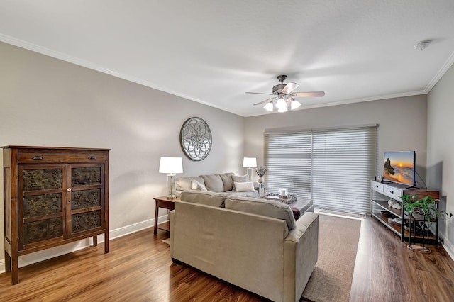 living room featuring ceiling fan, ornamental molding, and wood-type flooring