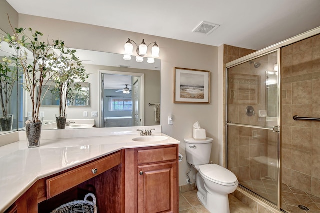 bathroom with ceiling fan, tile patterned flooring, vanity, toilet, and walk in shower