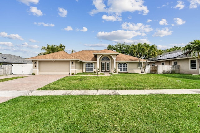 view of front of property featuring a garage and a front lawn