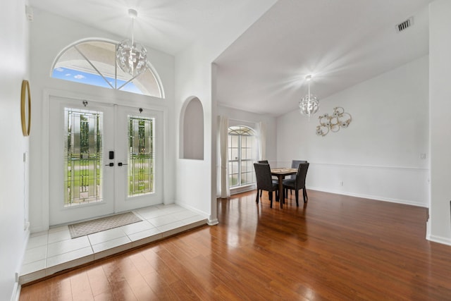 entryway with a chandelier, hardwood / wood-style floors, and a healthy amount of sunlight