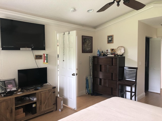 bedroom featuring ceiling fan, wood-type flooring, and crown molding