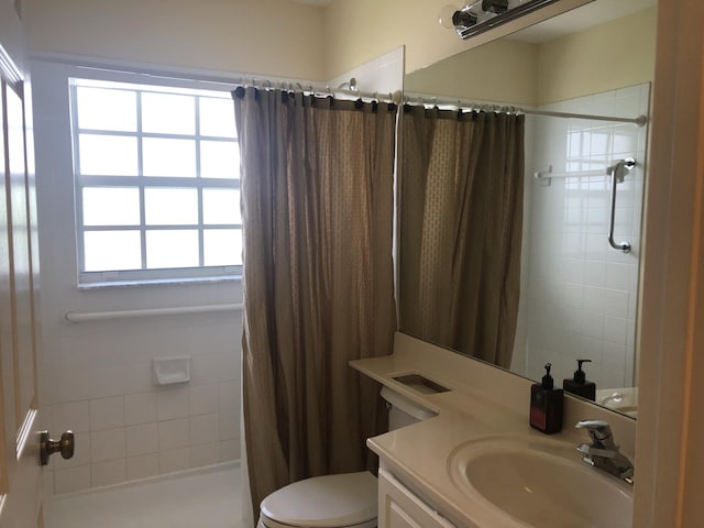 bathroom featuring a shower with curtain, toilet, and vanity