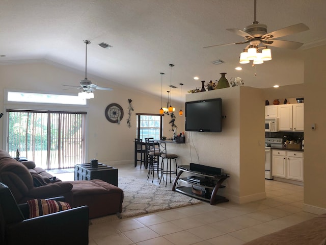 tiled living room featuring ceiling fan and lofted ceiling