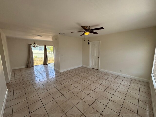 unfurnished room with baseboards, a ceiling fan, and light tile patterned floors