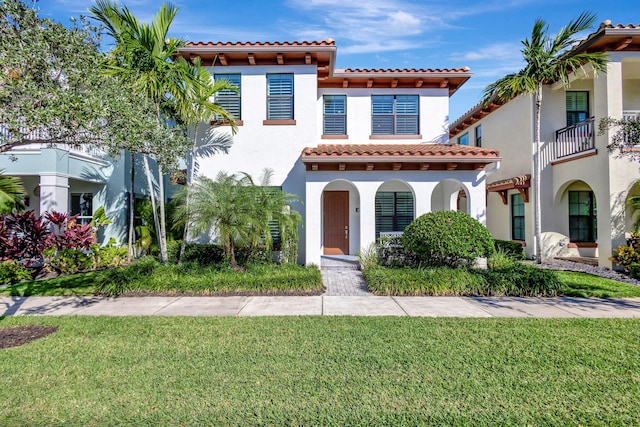 mediterranean / spanish-style house with a front yard