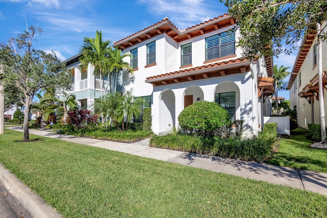 mediterranean / spanish-style home with a front lawn