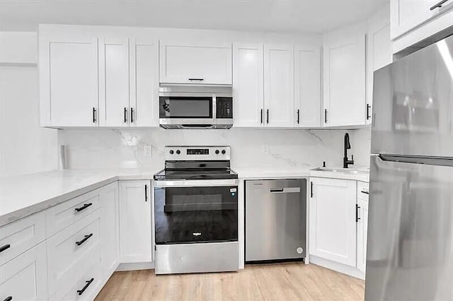 kitchen with white cabinetry and appliances with stainless steel finishes